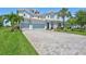 Beautiful two-story home with a three-car garage and a well-manicured lawn at 11913 Blue Hill Trl, Bradenton, FL 34211