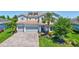 Charming two-story home with a three-car garage, a brick driveway, and meticulous landscaping at 11913 Blue Hill Trl, Bradenton, FL 34211