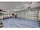 Spacious three-car garage with epoxy flooring and ample storage, ideal for car enthusiasts or hobbyists at 11913 Blue Hill Trl, Bradenton, FL 34211