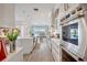 Modern kitchen with large island, stainless steel appliances, and views of the outdoor pool at 11913 Blue Hill Trl, Bradenton, FL 34211