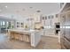 Spacious kitchen with white cabinetry, island seating, and modern stainless steel appliances at 11913 Blue Hill Trl, Bradenton, FL 34211