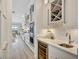 Elegant kitchen with sleek white cabinets, wine storage, and stainless steel appliances at 11913 Blue Hill Trl, Bradenton, FL 34211