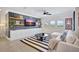 Cozy living room featuring shiplap accent wall, white sofa, and a striped rug at 11913 Blue Hill Trl, Bradenton, FL 34211