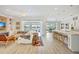 Open floor plan with a seamless flow between living room, kitchen, and outdoor spaces at 11913 Blue Hill Trl, Bradenton, FL 34211
