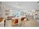 Bright, open-concept living room with hardwood floors and sliding doors to the pool at 11913 Blue Hill Trl, Bradenton, FL 34211