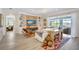 Spacious living room with stylish furniture, built-in shelving, and access to outdoor living area at 11913 Blue Hill Trl, Bradenton, FL 34211