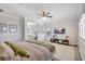 The main bedroom boasts a ceiling fan, TV, and an open view to the sitting area at 11913 Blue Hill Trl, Bradenton, FL 34211