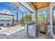 Outdoor kitchen with grill and bar, ideal for entertaining guests and enjoying the waterfront view at 11913 Blue Hill Trl, Bradenton, FL 34211