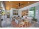 Inviting outdoor living space with a wood ceiling, seating, grill, and access to interior living spaces at 11913 Blue Hill Trl, Bradenton, FL 34211