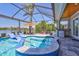 Beautiful screened-in pool with a spa, bar, and lake view providing a luxurious outdoor experience at 11913 Blue Hill Trl, Bradenton, FL 34211