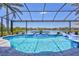 Stunning screened-in pool with waterfall feature overlooking the lake and the community beyond at 11913 Blue Hill Trl, Bradenton, FL 34211