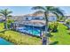 Aerial view of a screened-in pool with spa, surrounded by lush landscaping at 11913 Blue Hill Trl, Bradenton, FL 34211