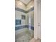 Custom tiled shower with glass door, built-in niche, and stylish fixtures at 11913 Blue Hill Trl, Bradenton, FL 34211