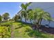 Lush side yard with manicured lawn and tropical landscaping, adding to the home's curb appeal at 11913 Blue Hill Trl, Bradenton, FL 34211