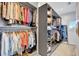 Well-organized walk-in closet with shelving, hanging rods, and a variety of clothing at 11913 Blue Hill Trl, Bradenton, FL 34211