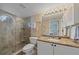 Elegant bathroom with a granite countertop, glass shower, and tasteful tile work at 1223 Siesta Bayside Dr # 1223, Sarasota, FL 34242