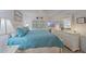 Tranquil bedroom featuring a plush blue comforter, white furniture, and serene decor elements at 1223 Siesta Bayside Dr # 1223, Sarasota, FL 34242