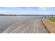 Beautiful view of waterway from wooden dock with bench at 1223 Siesta Bayside Dr # 1223, Sarasota, FL 34242
