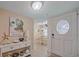 Inviting entryway featuring a decorative door with natural light and stylish decor leading into the dining room at 1223 Siesta Bayside Dr # 1223, Sarasota, FL 34242