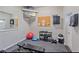 Well-equipped exercise room with weights, TV, mirror, and other workout equipment at 1223 Siesta Bayside Dr # 1223, Sarasota, FL 34242