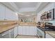 Modern kitchen featuring granite countertops, stainless steel appliances, and bright white cabinetry at 1223 Siesta Bayside Dr # 1223, Sarasota, FL 34242