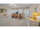 Open-concept living area with bar seating and an entry way to greet all guests at 1223 Siesta Bayside Dr # 1223, Sarasota, FL 34242