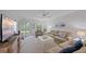 Cozy living room with a ceiling fan, bright windows, and a sliding glass door to the backyard at 1223 Siesta Bayside Dr # 1223, Sarasota, FL 34242