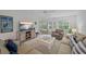 Comfortable living room with a ceiling fan, bright windows, and a sliding glass door to the backyard at 1223 Siesta Bayside Dr # 1223, Sarasota, FL 34242