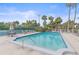 Inviting community pool with clear water, surrounded by lush landscaping and lounge chairs at 1223 Siesta Bayside Dr # 1223, Sarasota, FL 34242
