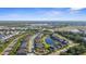 Beautiful aerial view of a Primary-planned community featuring mature landscaping, scenic ponds, and well-maintained homes at 12565 Ryegrass Loop, Parrish, FL 34219