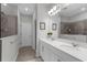 Modern bathroom featuring double sinks, quartz countertop, and a tiled walk-in shower at 12565 Ryegrass Loop, Parrish, FL 34219