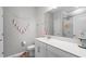 Bathroom featuring a white vanity with a quartz countertop and a shower-tub combo at 12565 Ryegrass Loop, Parrish, FL 34219