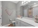 Bright bathroom featuring a white vanity with a quartz countertop and a shower-tub combo at 12565 Ryegrass Loop, Parrish, FL 34219