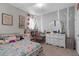 Stylish bedroom with whimsical tree-themed wall art, a comfortable bed, and ample storage at 12565 Ryegrass Loop, Parrish, FL 34219