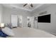 Bright bedroom featuring a ceiling fan, tray ceiling, plush carpet, and comfortable seating at 12565 Ryegrass Loop, Parrish, FL 34219