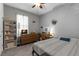 Cozy bedroom with soft gray walls, a ceiling fan, and a comfortable full-sized bed at 12565 Ryegrass Loop, Parrish, FL 34219