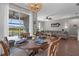 Open-concept dining area with sliding glass doors leading to a screened patio and pool at 12565 Ryegrass Loop, Parrish, FL 34219