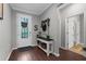 Welcoming foyer with wood-look floors, stylish decor, and a view of the front door and entryway at 12565 Ryegrass Loop, Parrish, FL 34219