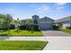 Charming single story home featuring a manicured front yard and neutral color scheme at 12565 Ryegrass Loop, Parrish, FL 34219