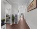 Inviting hallway with wood-look flooring, neutral walls, and views into adjacent rooms at 12565 Ryegrass Loop, Parrish, FL 34219