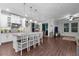 Gourmet kitchen features a large center island with seating, pendant lighting, and modern appliances at 12565 Ryegrass Loop, Parrish, FL 34219