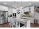 Elegant kitchen featuring a large island with seating and stainless steel appliances at 12565 Ryegrass Loop, Parrish, FL 34219