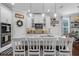 Gourmet kitchen featuring a large island with seating and pristine white cabinetry at 12565 Ryegrass Loop, Parrish, FL 34219