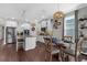 Well-lit kitchen with stainless steel appliances, island seating, and an adjacent dining area at 12565 Ryegrass Loop, Parrish, FL 34219