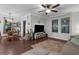 Spacious living room with hard wood floors, neutral paint, and a large sectional sofa at 12565 Ryegrass Loop, Parrish, FL 34219