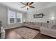 Cozy living room featuring hardwood floors, large windows, and comfortable seating at 12565 Ryegrass Loop, Parrish, FL 34219