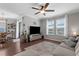 Open-concept living room featuring hardwood floors, a ceiling fan, and views to dining area and patio at 12565 Ryegrass Loop, Parrish, FL 34219