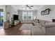 Bright living room with hardwood floors, neutral paint, and a large sectional sofa at 12565 Ryegrass Loop, Parrish, FL 34219