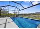Stunning screened-in pool with a serene lake view, perfect for relaxation and recreation at 12565 Ryegrass Loop, Parrish, FL 34219
