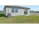 New home's backyard features a sliding glass door, small lawn, and central air conditioning unit at 14061 Crutchfield Ct, Parrish, FL 34219